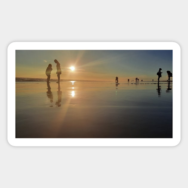 Silhouetted people in a row on a sand beach. Sticker by kall3bu